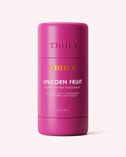 A pink stick of Truly Beauty Unicorn Fruit Skin Brightening and Smoothing Deodorant with mandelic acid and niacinamide, designed to smooth, brighten, and reduce underarm discoloration, shown against a light background.