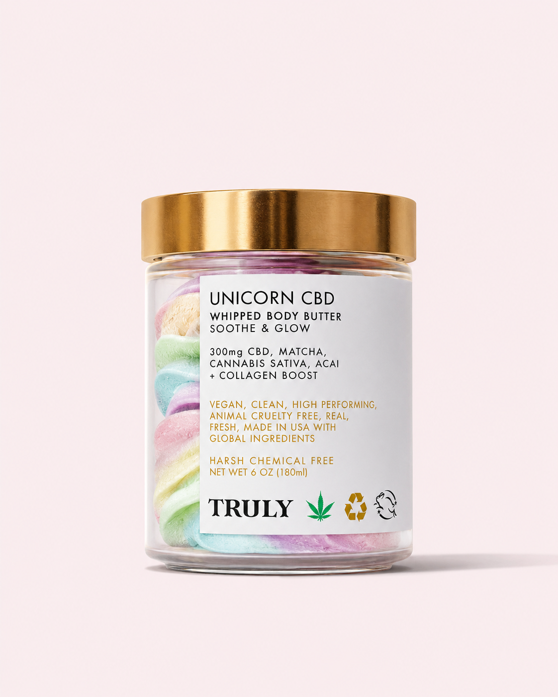 A glass jar topped with a gold lid holds pastel rainbow whipped body butter. The label displays Unicorn CBD Soothe & Glow Whipped Body Butter, featuring soothing ingredients like CBD and matcha to help calm inflammation. The brand name Truly Beauty appears at the bottom, with the playful phrase “Unicorn Hemp” included on the packaging.