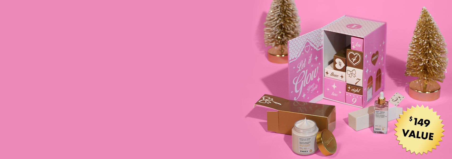 2025 Beauty Advent Calendar with small Christmas trees on a pink background