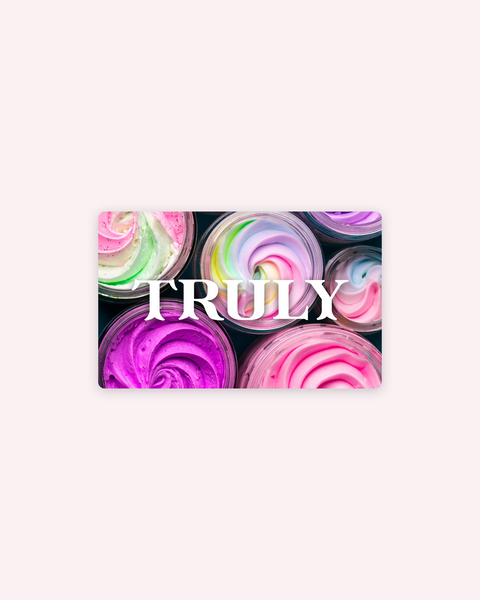 Jars of colorful swirled pastel creams are arranged in a grid on a soft pink background, with “Truly Gift Card” by Rise.ai highlighted in bold white letters at the center—perfect for winter skincare gifting.